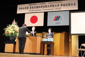 Graduates receiving their diploma.